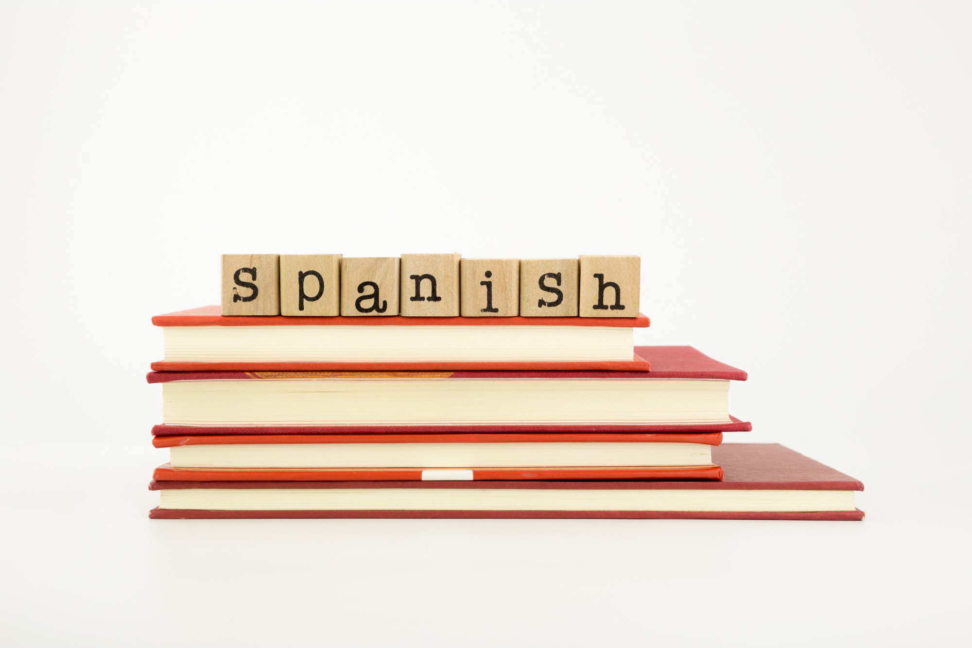Spanish word on wood stamps stack on books language and academic concept.